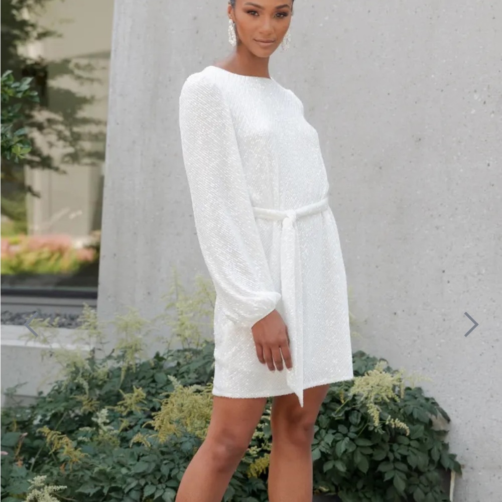 Excellent condition. Only one once. White sequin shift dress with belt.